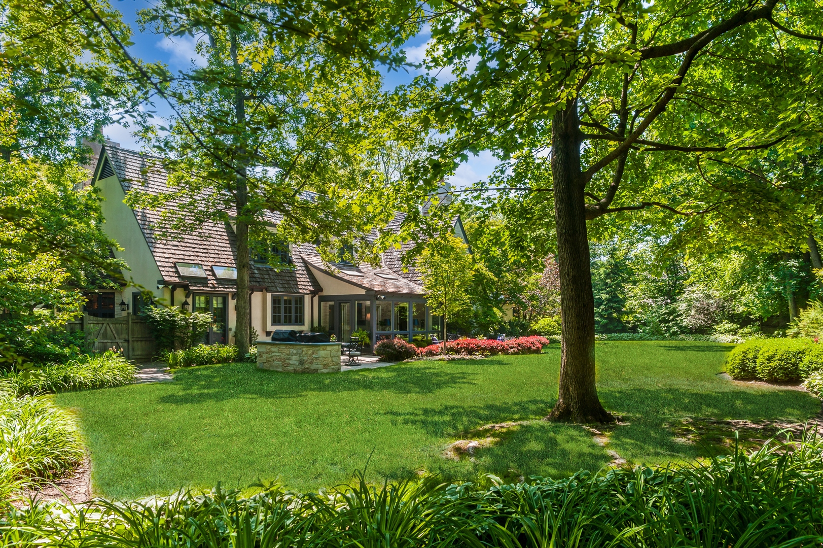 370 North Mayflower Road Lake Forest, IL 60045 - Photo 24 of 29 a front view of a house with a yard table and trees