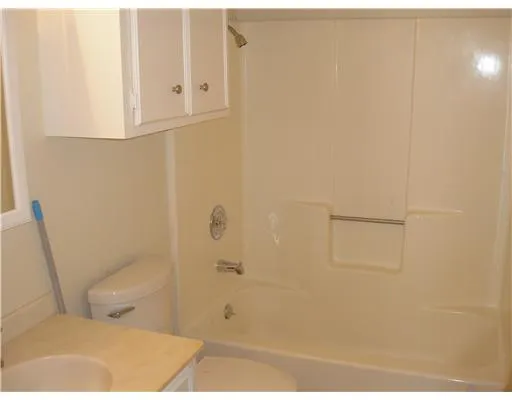 a bathroom with a toilet and shower