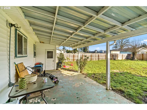 a view of a porch with furniture and a yard