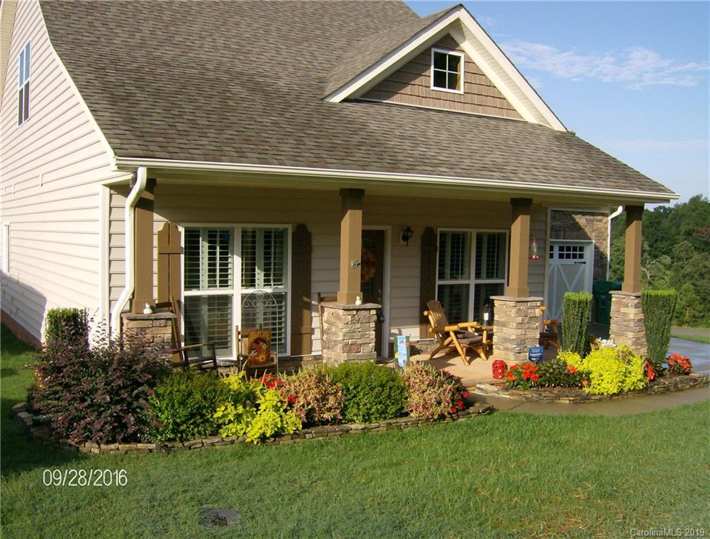 206 Broad Street Locust, NC 28097 - Photo 1 of 5 a front view of a house with a garden and plants