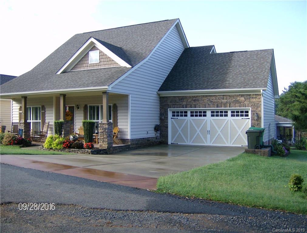 206 Broad Street Locust, NC 28097 - Photo 2 of 5 a front view of a house with a garden and yard