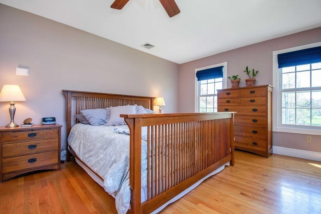 51 Steele Road Enfield, CT 06082 - Photo 22 of 42 a bedroom with a bed and wooden floor