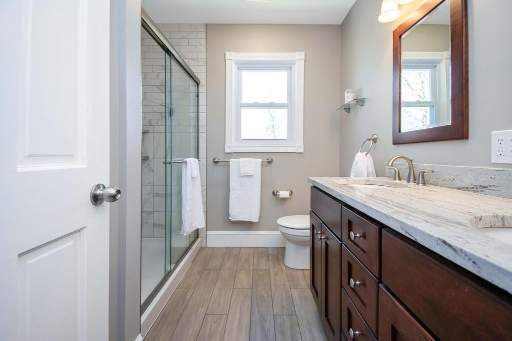 51 Steele Road Enfield, CT 06082 - Photo 24 of 42 a bathroom with a granite countertop sink toilet and shower