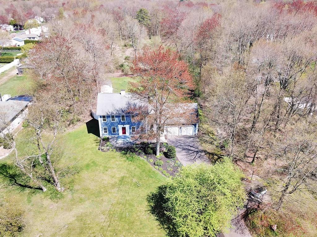 51 Steele Road Enfield, CT 06082 - Photo 5 of 42 a backyard of a house with large trees and a yard