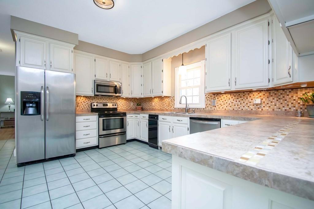 51 Steele Road Enfield, CT 06082 - Photo 6 of 42 a kitchen with granite countertop a refrigerator sink and cabinets