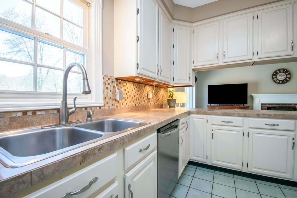 51 Steele Road Enfield, CT 06082 - Photo 7 of 42 a kitchen with white cabinets and sink