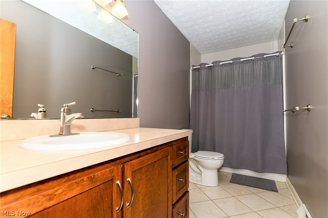 4425 Max Road North Canton, OH 44720 - Photo 15 of 30 *LARGE FULL BATHROOM W/GREY WALLS, 4 LIGHT SCONCE, WHITE TILED SHOWER SURROUND & CERAMIC TILE FLOORING ~