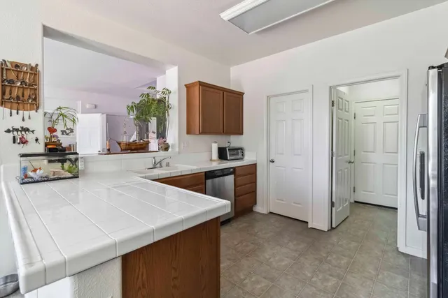 a kitchen with a sink a stove and refrigerator