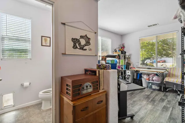 a living room with furniture a window and a flat screen tv