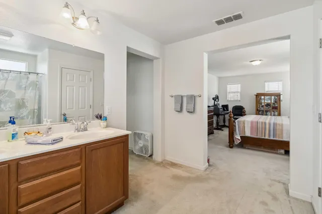 a bathroom with a sink vanity and a mirror
