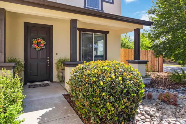 a view of a house with potted plants