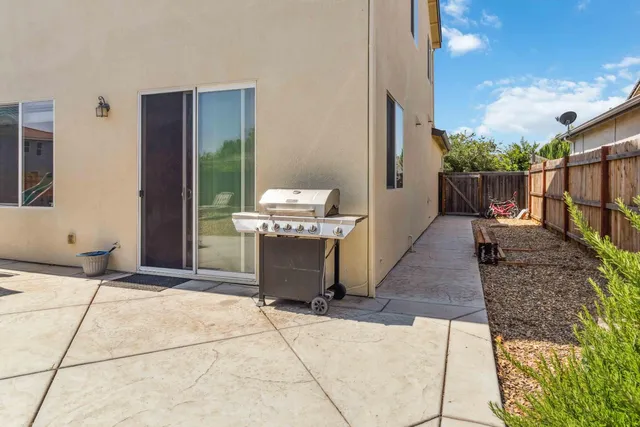 a backyard of a house with lots of green space and wooden fence