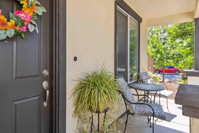 a view of a porch with furniture and a potted plant