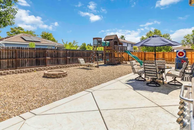 a view of a backyard with sitting area