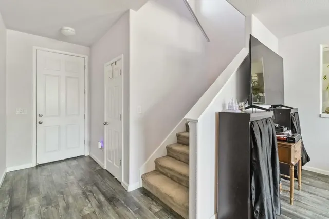 a view of entryway with wooden floor and stairs
