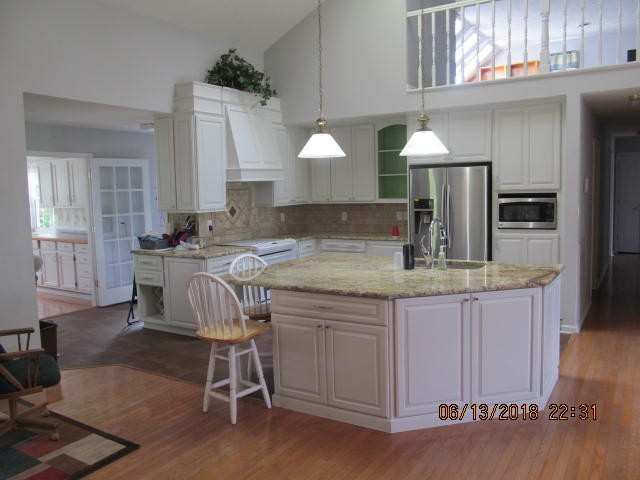 8200 Greenbriar Road Talbott, TN 37877 - Photo 3 of 18 a kitchen with kitchen island granite countertop a sink a stove a dining table and chairs