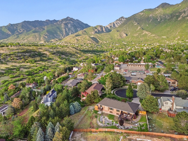 2342 Charros Road Sandy, UT 84092 - Photo 80 of 94 Expansive mountain backdrop with a residential area featuring mature trees and established landscaping