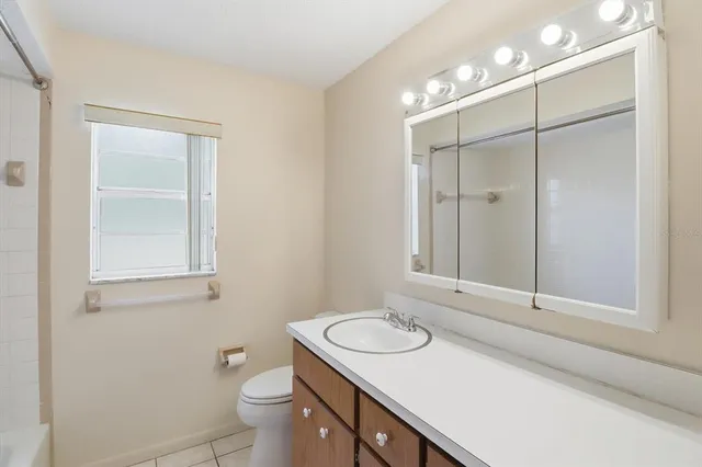 a bathroom with a sink toilet and vanity