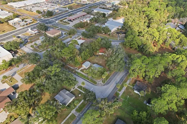 an aerial view of a house with garden space and street view