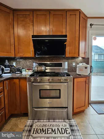 a kitchen with stainless steel appliances a stove a sink and a microwave