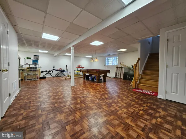 a room with pool table and windows