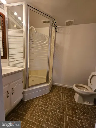 a bathroom with a shower and a sink