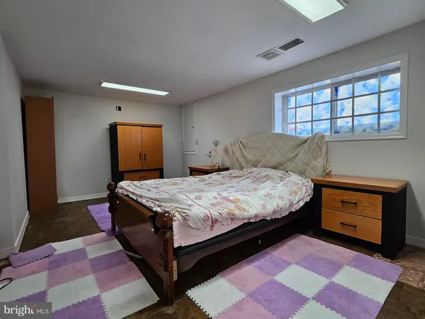 a bed sitting in a bedroom next to a window