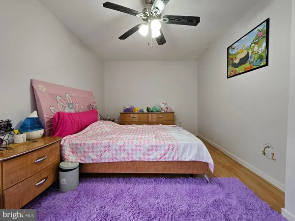a bedroom with a bed and painting on the wall