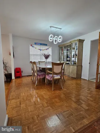 a view of a dining room that has a table and chairs in it