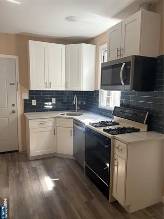 a kitchen with a stove a sink and a microwave