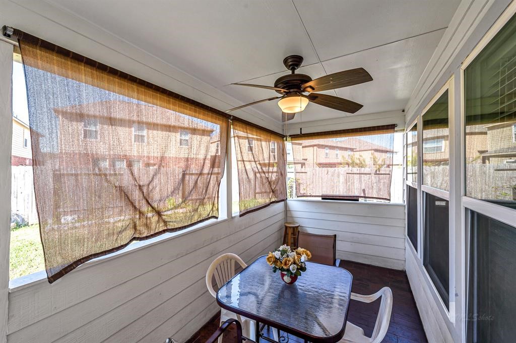 3203 Dale Ridge Trail Houston, TX 77084 - Photo 28 of 33 Charming enclosed back porch (sunroom) equipped with a ceiling fan—perfect for outdoor dining or relaxing.