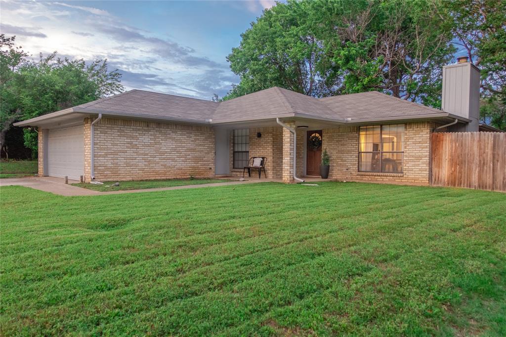 217 Ginger Lane Euless, TX 76039 - Photo 1 of 1 a brick house with garden area in front of it