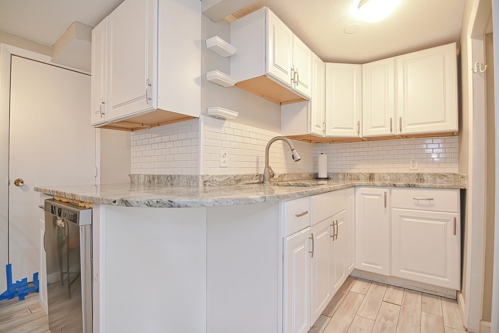 8 Maple Avenue Danvers, MA 01923 - Photo 11 of 42 a kitchen with stainless steel appliances granite countertop a sink and a stove