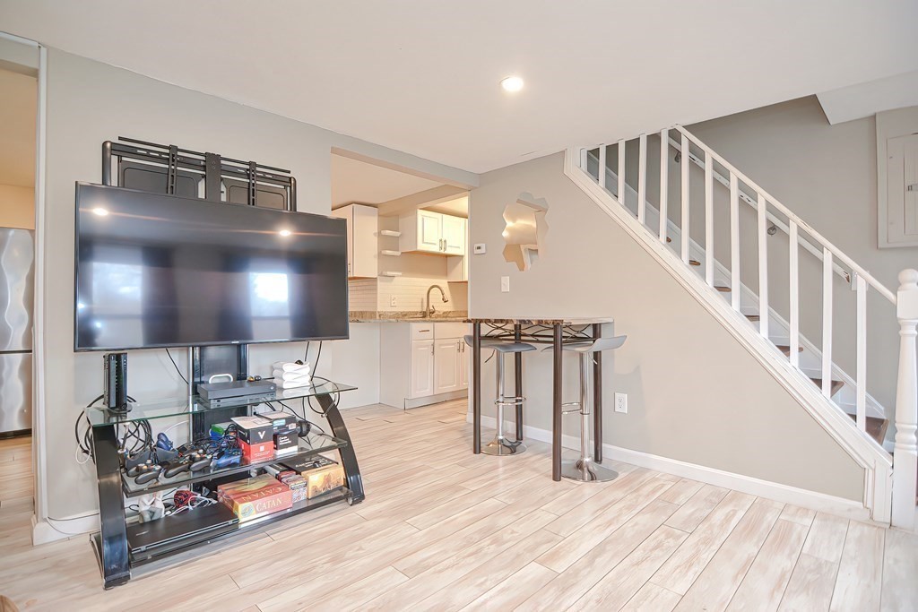 8 Maple Avenue Danvers, MA 01923 - Photo 14 of 42 a view of a livingroom with furniture and stairs