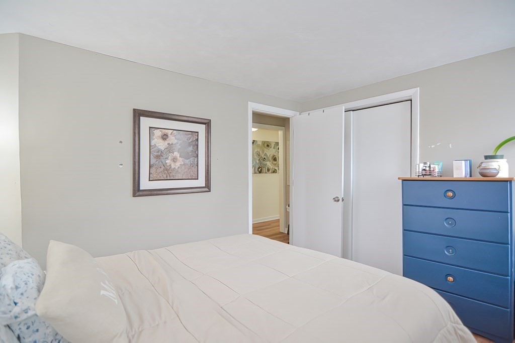 8 Maple Avenue Danvers, MA 01923 - Photo 28 of 42 a bedroom with a bed and a mirror