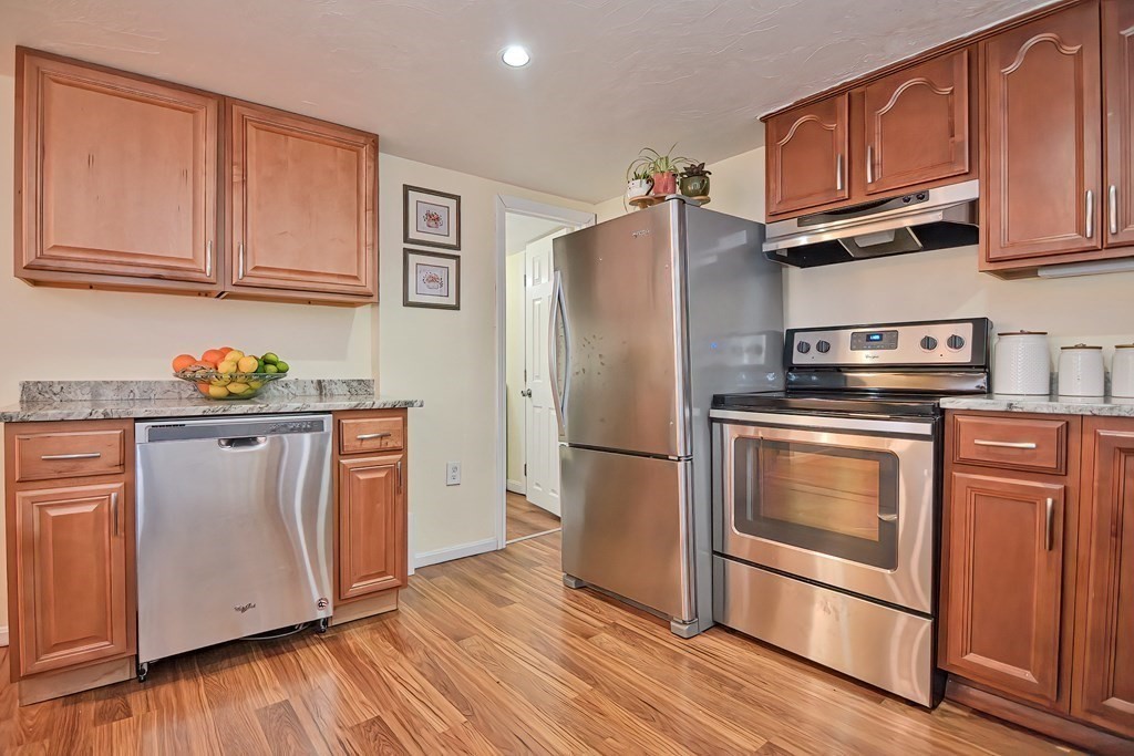 8 Maple Avenue Danvers, MA 01923 - Photo 3 of 42 a kitchen with granite countertop wooden floors stainless steel appliances and cabinets