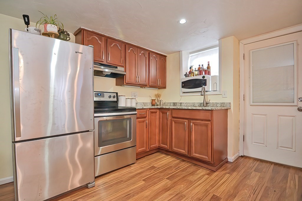 8 Maple Avenue Danvers, MA 01923 - Photo 4 of 42 a kitchen with granite countertop a refrigerator and a sink