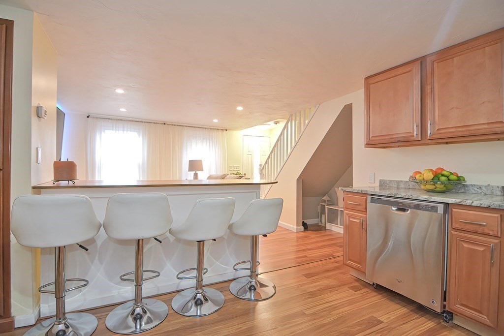 8 Maple Avenue Danvers, MA 01923 - Photo 5 of 42 a view of kitchen with stainless steel appliances granite countertop cabinets and wooden floor
