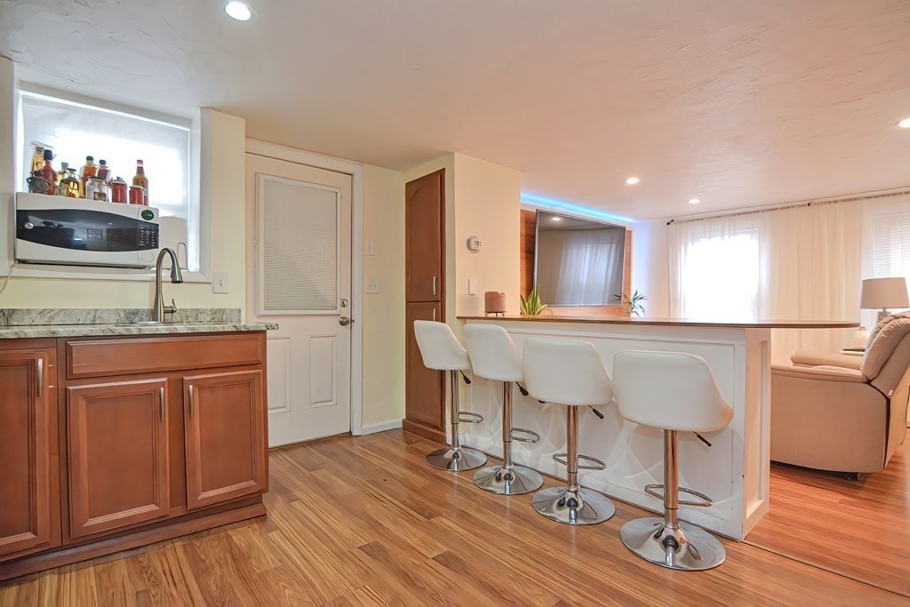 8 Maple Avenue Danvers, MA 01923 - Photo 6 of 42 a living room with granite countertop furniture and a wooden floor