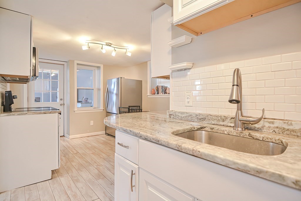 8 Maple Avenue Danvers, MA 01923 - Photo 10 of 42 a bathroom with a sink double vanity and a mirror