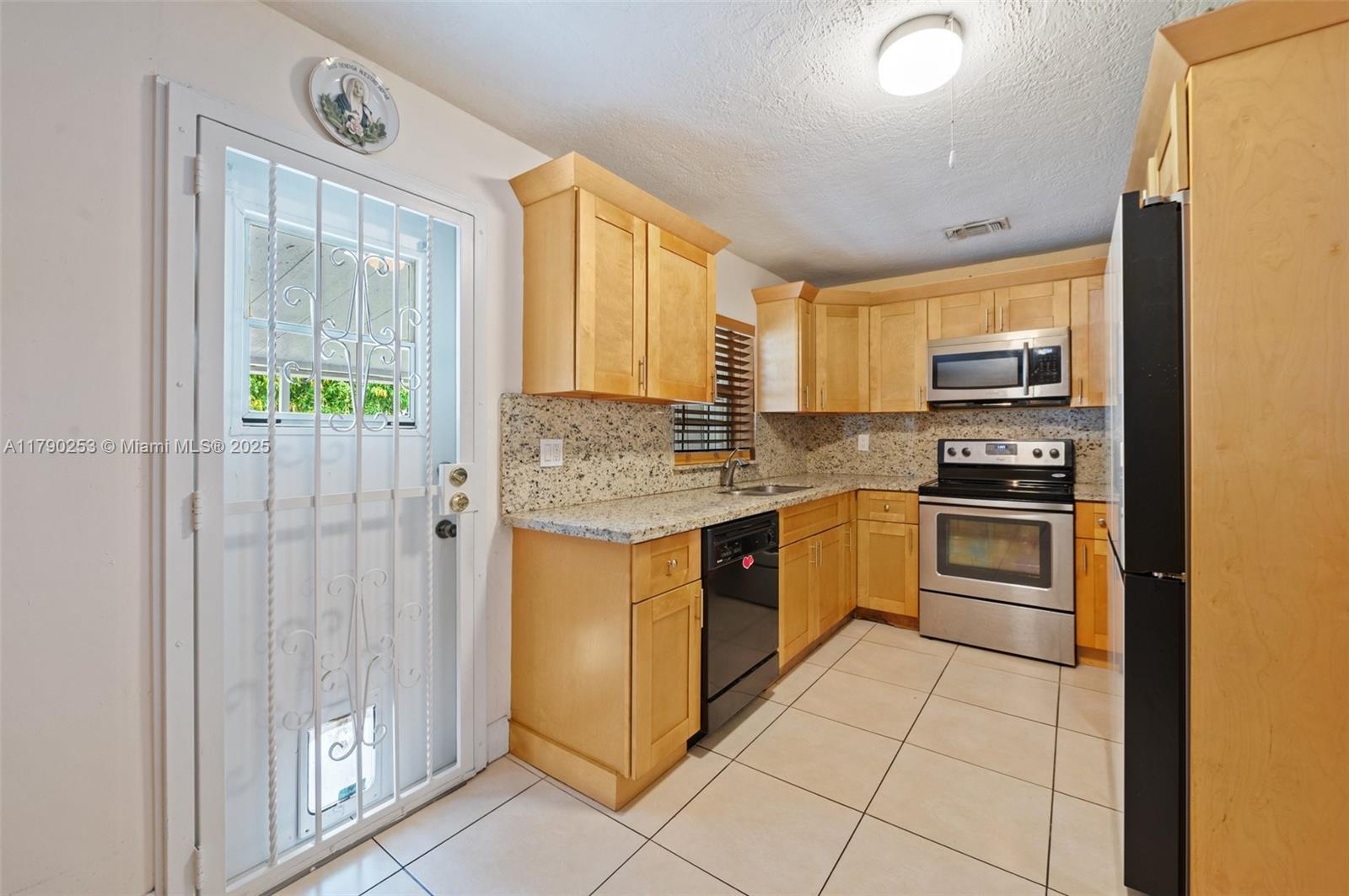 5731 Simms Street Hollywood, FL 33021 - Photo 12 of 33 a kitchen with a refrigerator sink and stove
