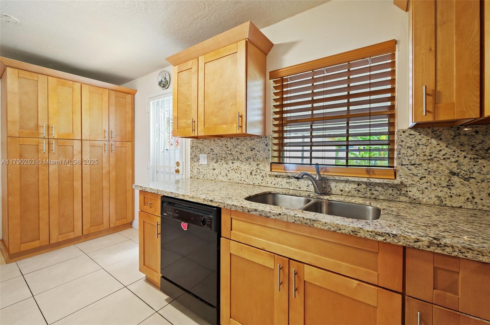 5731 Simms Street Hollywood, FL 33021 - Photo 14 of 33 a kitchen with stainless steel appliances granite countertop a sink and a cabinets