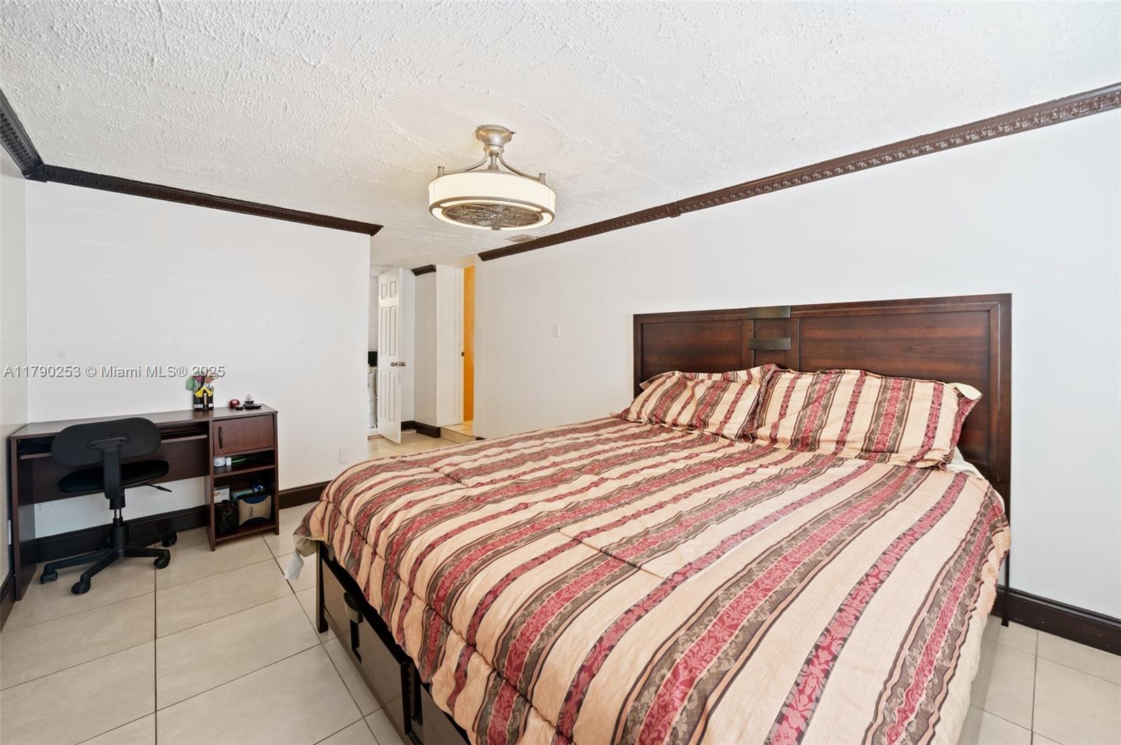 5731 Simms Street Hollywood, FL 33021 - Photo 17 of 33 a bedroom with a bed and a chandelier