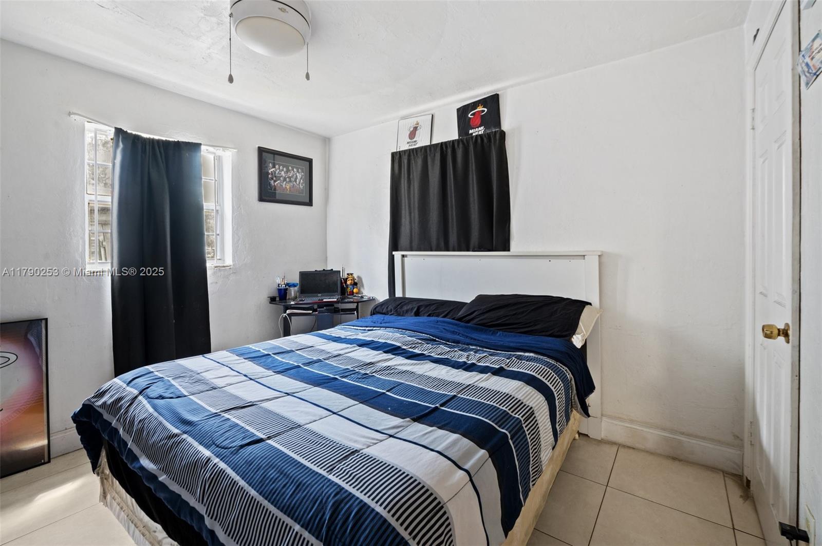 5731 Simms Street Hollywood, FL 33021 - Photo 19 of 33 a bedroom with a bed and a flat tv screen