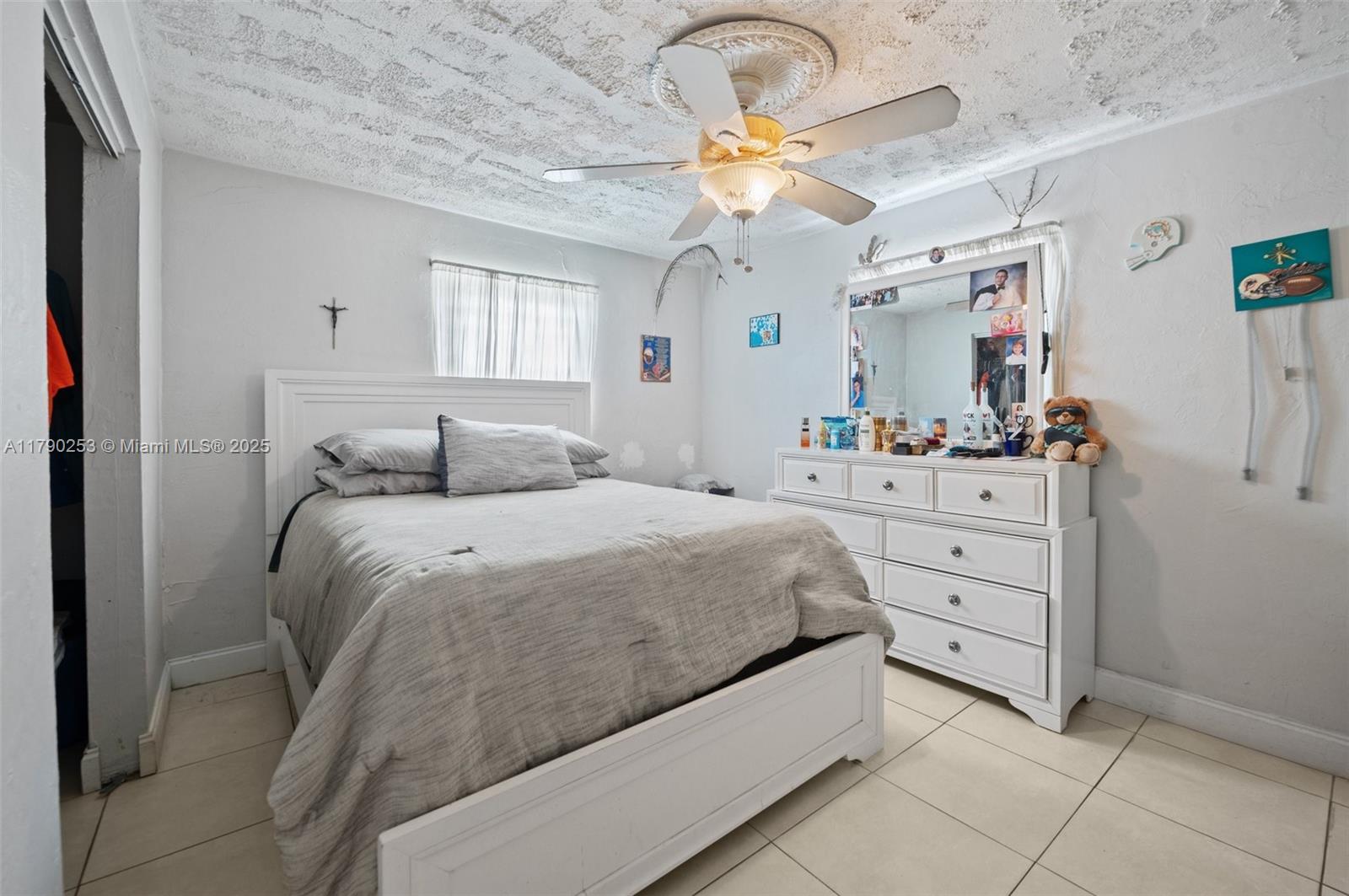 5731 Simms Street Hollywood, FL 33021 - Photo 20 of 33 a bedroom with a bed and a chandelier