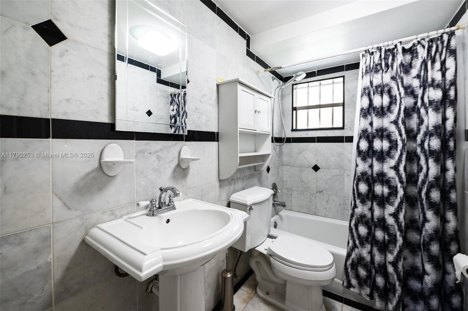 5731 Simms Street Hollywood, FL 33021 - Photo 21 of 33 a bathroom with a sink toilet and shower