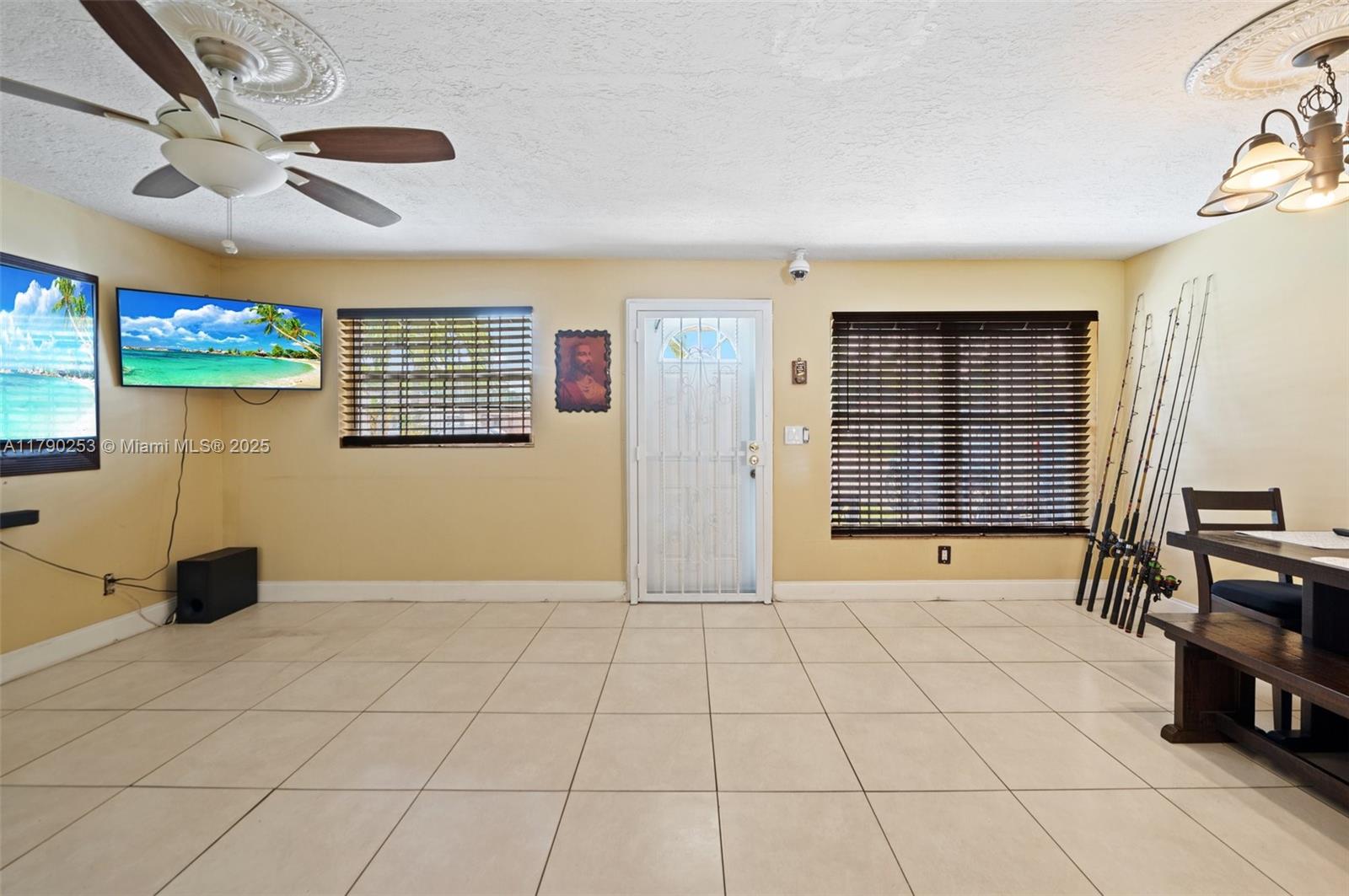 5731 Simms Street Hollywood, FL 33021 - Photo 6 of 33 a view of an empty room with window and chandelier fan