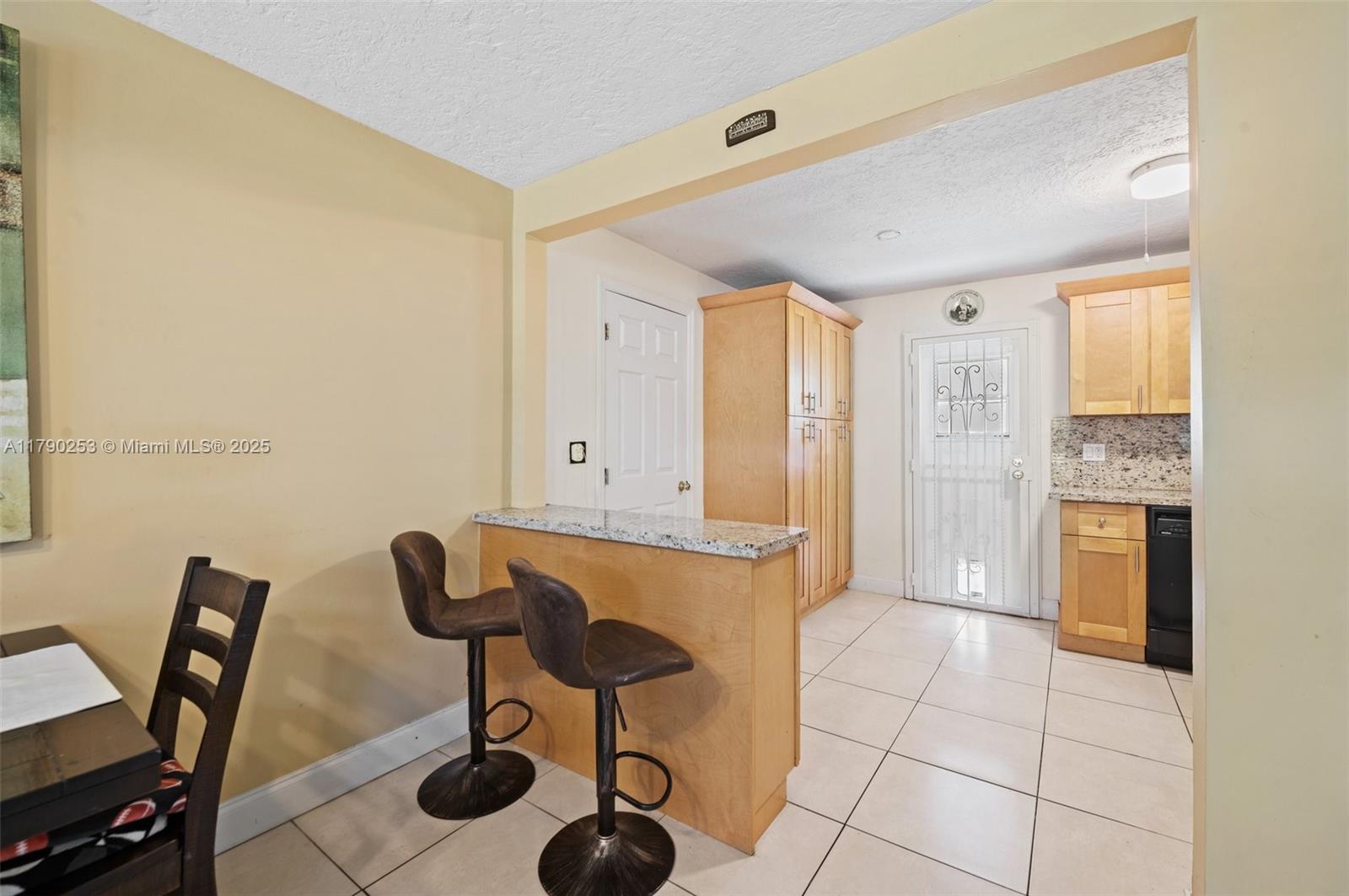 5731 Simms Street Hollywood, FL 33021 - Photo 10 of 33 a view of a kitchen with chair and table