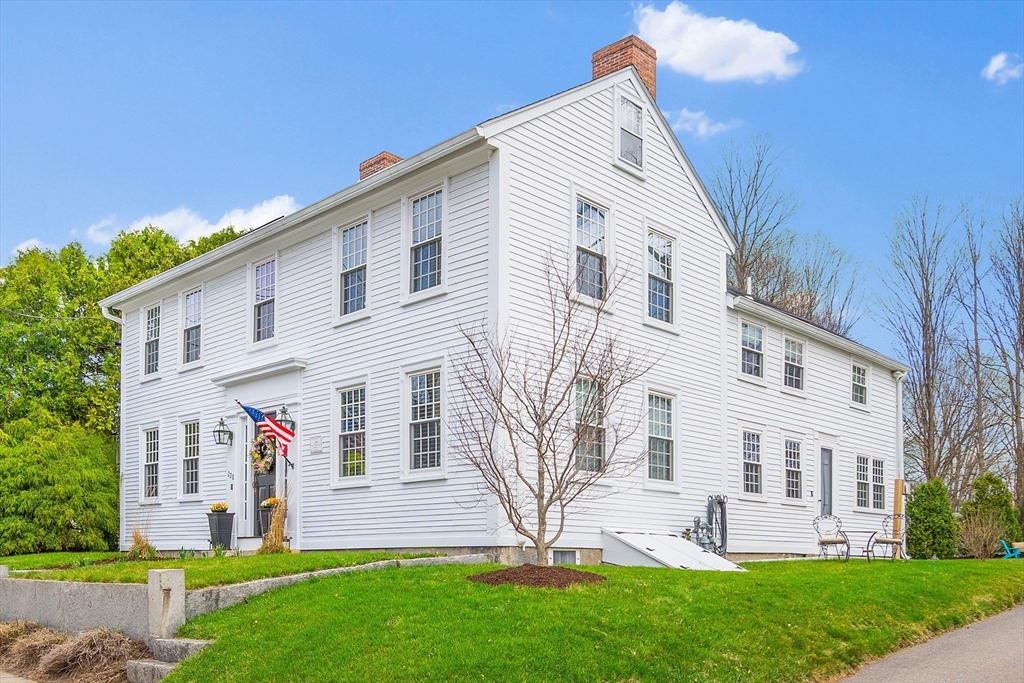 228 Main Street Groton, MA 01450 - Photo 2 of 33 a front view of a house with a yard and outdoor seating