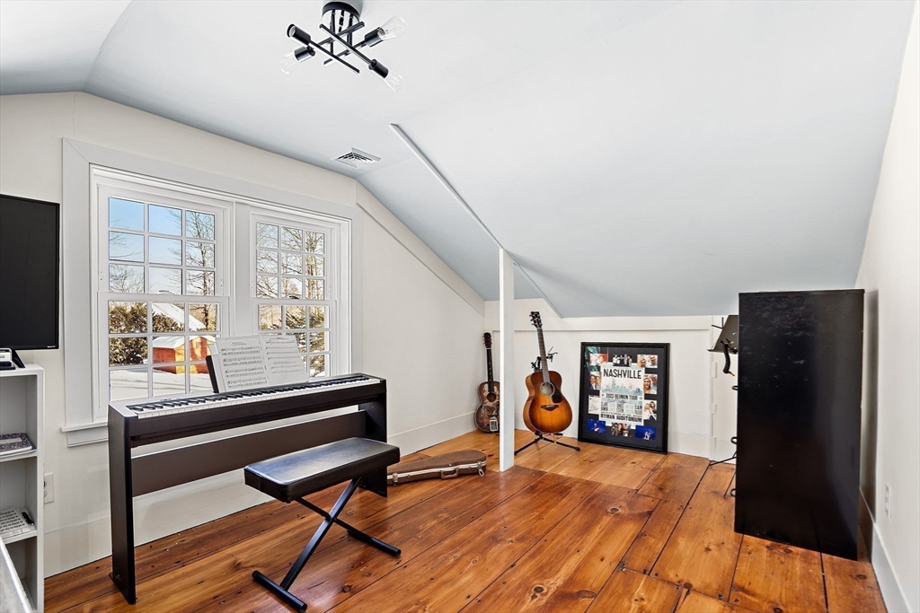 228 Main Street Groton, MA 01450 - Photo 26 of 33 a living room with furniture and a flat screen tv